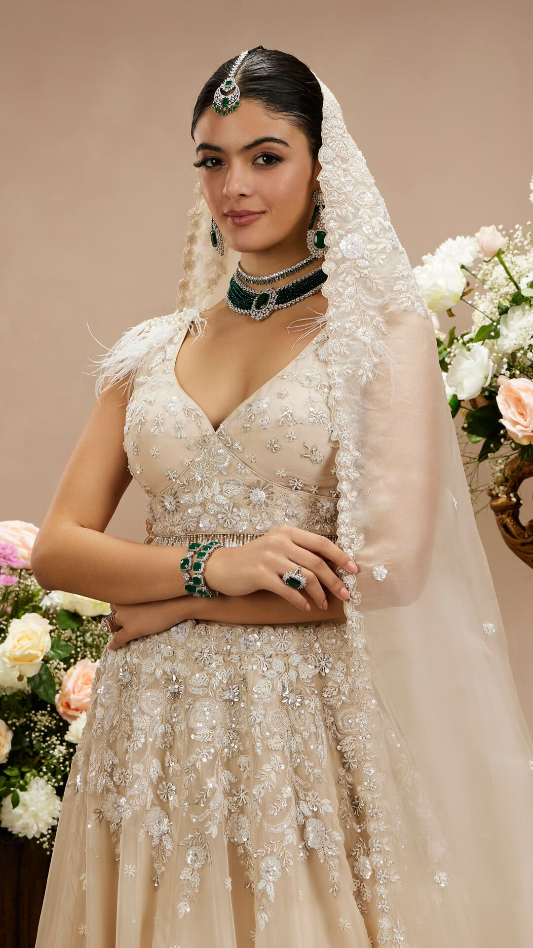 woman wearing richly embellished lehenga with intricate detailing and luxurious adornments.